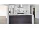 Close-up of the kitchen island with cooktop, white countertop, and contrasting dark base at 8335 E Montecito Ave, Scottsdale, AZ 85251