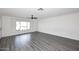 Bright living room featuring wood-look floors, ceiling fan, and updated fixtures at 8335 E Montecito Ave, Scottsdale, AZ 85251