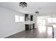 Bright living room featuring modern lighting, sleek wet bar area, and light gray flooring at 8335 E Montecito Ave, Scottsdale, AZ 85251