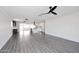 Expansive living space with light gray flooring connects a modern wet bar to a bright, renovated kitchen at 8335 E Montecito Ave, Scottsdale, AZ 85251