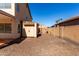 Backyard featuring gravel, a storage shed, and a block wall fence for privacy at 835 E Stirrup Ln, San Tan Valley, AZ 85143