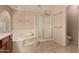 This is a view of a bathroom with a tub and shower at 835 E Stirrup Ln, San Tan Valley, AZ 85143