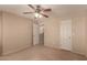 Neutral bedroom with standard ceiling fan and view into the next room at 835 E Stirrup Ln, San Tan Valley, AZ 85143