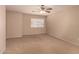 This bedroom features neutral carpeting and a window at 835 E Stirrup Ln, San Tan Valley, AZ 85143