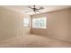 Bright bedroom with two windows and neutral carpet at 835 E Stirrup Ln, San Tan Valley, AZ 85143