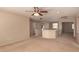 This is a view of a bonus room with neutral carpeting and a ceiling fan at 835 E Stirrup Ln, San Tan Valley, AZ 85143