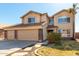 Two story home featuring a tile roof, three car garage, desert landscaping, and walkway at 835 E Stirrup Ln, San Tan Valley, AZ 85143