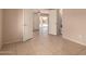 Hallway leading to living areas, showcasing tile floors and neutral color palette at 835 E Stirrup Ln, San Tan Valley, AZ 85143