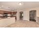 Kitchen adjacent to living space, showcasing wooden cabinetry and granite countertops at 835 E Stirrup Ln, San Tan Valley, AZ 85143