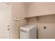 Inside laundry room with washer and overhead shelf at 835 E Stirrup Ln, San Tan Valley, AZ 85143