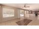 Bright living room featuring tile flooring, neutral walls, and sliding glass doors to the backyard at 835 E Stirrup Ln, San Tan Valley, AZ 85143