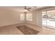 A living room featuring tile flooring, light walls, and a sliding glass door to the pool at 835 E Stirrup Ln, San Tan Valley, AZ 85143