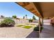 Spacious backyard featuring a covered patio, gravel ground cover, and block wall at 8538 E Vista Dr, Scottsdale, AZ 85250