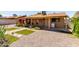 Back of house with gravel ground cover, covered patio, laundry machine, and small decorative yard at 8538 E Vista Dr, Scottsdale, AZ 85250
