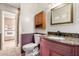 Cozy bathroom with granite counter, decorative cabinet, and toilet with unique wainscoting at 8538 E Vista Dr, Scottsdale, AZ 85250