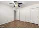 Bedroom features modern ceiling fan, wood-look flooring, with closet and entry doors, bright and airy at 8538 E Vista Dr, Scottsdale, AZ 85250