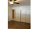 Bedroom with a view into the ensuite, wood-look floors, and a ceiling fan at 8538 E Vista Dr, Scottsdale, AZ 85250