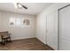 Clean bedroom with wood-look floors, window with wood shutters, and a closet with traditional sliding doors at 8538 E Vista Dr, Scottsdale, AZ 85250