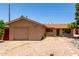 Exterior of single-story home features a well-kept front yard with low maintenance landscaping and an attached garage at 8538 E Vista Dr, Scottsdale, AZ 85250