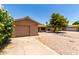 View of single-story home and attached garage with rock landscaping, healthy tree, and well maintained lawn at 8538 E Vista Dr, Scottsdale, AZ 85250