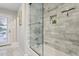 Elegant bathroom showcasing marble-tiled shower and glass door with modern fixtures at 8709 E Mackenzie Dr, Scottsdale, AZ 85251