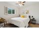 Cozy bedroom with white bedding, stylish decor, and bright window with shutters at 8709 E Mackenzie Dr, Scottsdale, AZ 85251