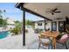 Covered patio with ceiling fans and outdoor dining area overlooking the pool at 8709 E Mackenzie Dr, Scottsdale, AZ 85251