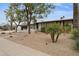 Inviting home exterior with well-maintained lawn, mature trees and walkway at 8709 E Mackenzie Dr, Scottsdale, AZ 85251