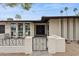 Charming front entrance with stylish gate and outdoor seating area at 8709 E Mackenzie Dr, Scottsdale, AZ 85251