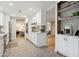 Modern kitchen featuring white cabinets, stainless steel appliances, and decorative backsplash at 8709 E Mackenzie Dr, Scottsdale, AZ 85251