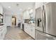 Bright, stylish kitchen with stainless steel fridge and decorative tile flooring at 8709 E Mackenzie Dr, Scottsdale, AZ 85251