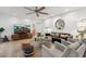 Inviting living room featuring comfortable seating, a modern ceiling fan, and stylish decor at 8709 E Mackenzie Dr, Scottsdale, AZ 85251