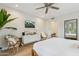 Light and bright main bedroom with hardwood floors, ceiling fan, and backyard view at 8709 E Mackenzie Dr, Scottsdale, AZ 85251