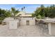 This outdoor kitchen and bar area is the perfect place for entertaining at 8709 E Mackenzie Dr, Scottsdale, AZ 85251