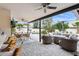 Relax in this covered patio, complete with tv, dining and lounge area, the perfect outdoor oasis at 8709 E Mackenzie Dr, Scottsdale, AZ 85251