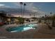 Backyard oasis featuring a refreshing pool, cozy patio, and beautiful landscape with palm trees at 8709 E Mackenzie Dr, Scottsdale, AZ 85251