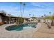 Desert landscaped pool with lounge furniture and covered seating areas at 8709 E Mackenzie Dr, Scottsdale, AZ 85251