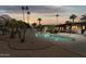 Inviting backyard pool at dusk with lush landscaping and palm trees at 8709 E Mackenzie Dr, Scottsdale, AZ 85251