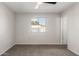 Cozy bedroom with neutral walls, plush carpeting, and a bright window at 9033 N 15Th Dr, Phoenix, AZ 85021