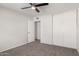 Bedroom with plush carpet, ceiling fan, and a closet with sliding doors at 9033 N 15Th Dr, Phoenix, AZ 85021