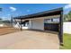 Carport of a single-story home with a white door and adjacent fence at 9033 N 15Th Dr, Phoenix, AZ 85021