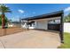 Carport of a single-story home with a white door and adjacent fence at 9033 N 15Th Dr, Phoenix, AZ 85021