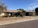 Single level home with a small carport and extended covered parking at 9033 N 15Th Dr, Phoenix, AZ 85021