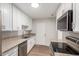 Bright kitchen featuring granite countertops, stainless steel appliances, and white cabinets at 9033 N 15Th Dr, Phoenix, AZ 85021