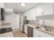 Modern kitchen with stainless steel appliances and white cabinetry at 9033 N 15Th Dr, Phoenix, AZ 85021