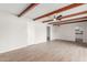Spacious living room with wood beam ceiling and view to the kitchen at 9033 N 15Th Dr, Phoenix, AZ 85021