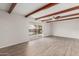 Spacious living room with wood beam ceiling and view to the backyard at 9033 N 15Th Dr, Phoenix, AZ 85021