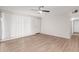 Bright living room with fan, wood floors, and door to hallway at 9033 N 15Th Dr, Phoenix, AZ 85021