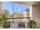 Balcony with wrought iron railing and a view of tall palm trees and the community at 9275 E Mission Ln # 206, Scottsdale, AZ 85258