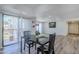 Inviting dining area with modern table set, wood floors, and sliding door to the balcony at 9275 E Mission Ln # 206, Scottsdale, AZ 85258